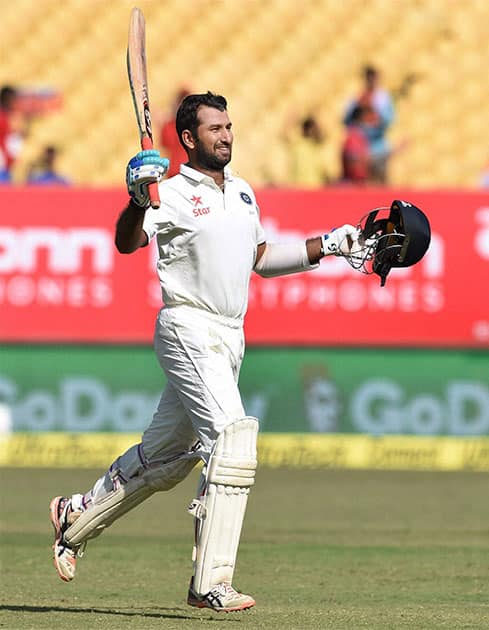 Cheteshwar Pujara celebrates after completing his century on the third day of the first Test match against England in Rajkot Cheteshwar Pujara celebrates after completing his century on the third day of the first Test match against England in Rajkot