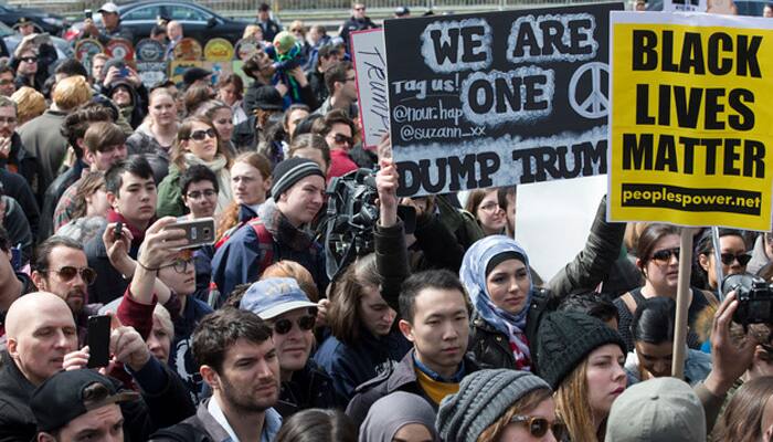 Anti-Donald Trump protesters march amid tear gas, flash grenades