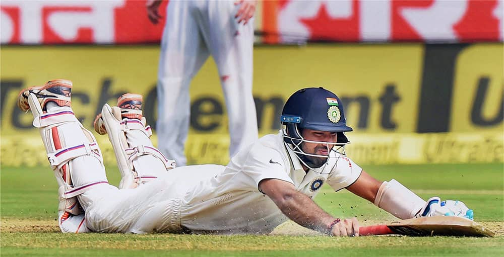 Cheteshwar Pujara dives to complete a run during the 1st day of the 2nd Test cricket match against England in Visakhapatnam