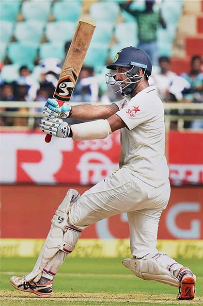 Cheteshwar Pujara hits a shot during the 1st day of the 2nd Test cricket match against England in Visakhapatnam