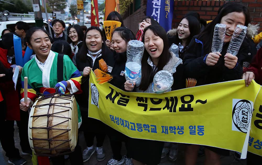 South Korean high school girls cheer for their senior classmates taking the College Scholastic Ability Test in Seoul, South Korea
