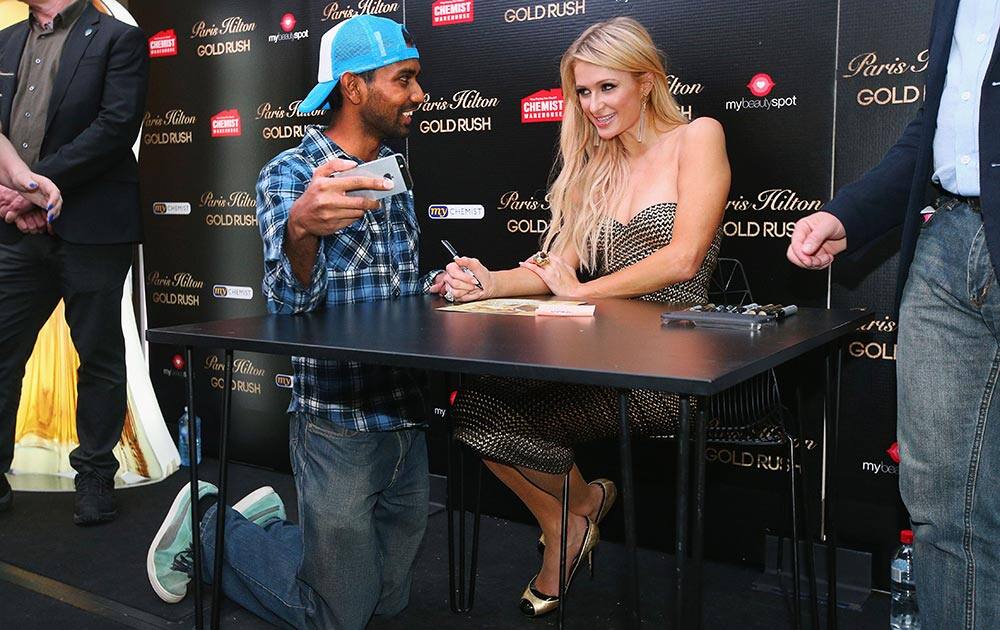 Paris Hilton listens to a fan during a Q&A with fans