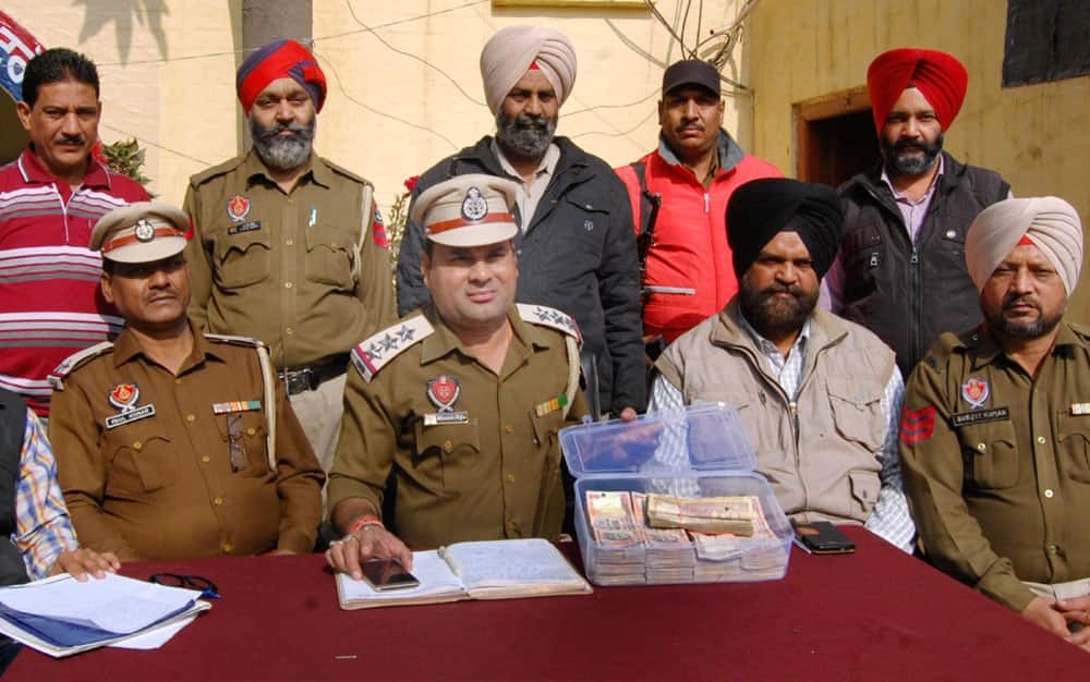 Police personals showing 11 lakh currency notes
