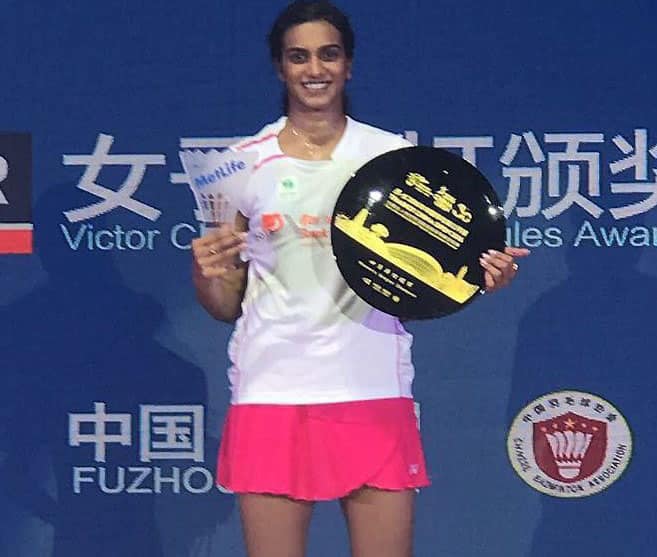 PV Sindhu poses with trophy