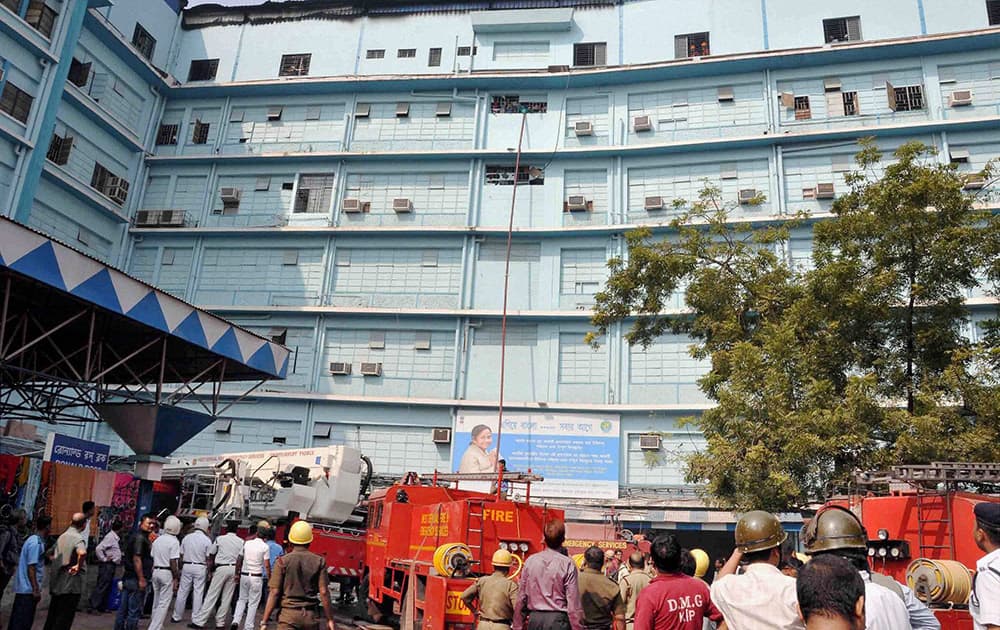 Police and fire brigade personnel at the Ronald Ross building of the SSKM Hospital, where fire broke out, in Kolkata