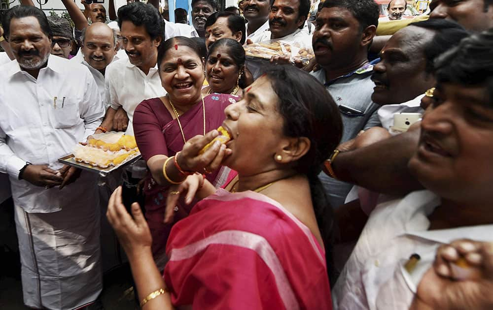 AIADMK cadres celebrating for their party's victory of three Assembly bypolls in front of Apollo Hospital where Chief Minister J Jayalalithaa is undergoing treatment, in Chennai