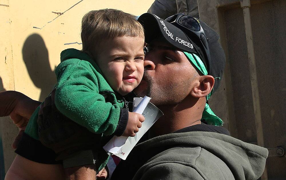 iraqi soldier kisses a boy