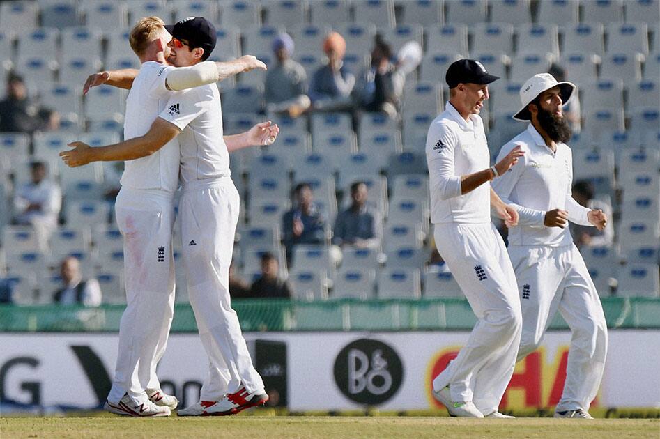 England players celebrate the wicket of Indian batsman Ravichandran Ashwin