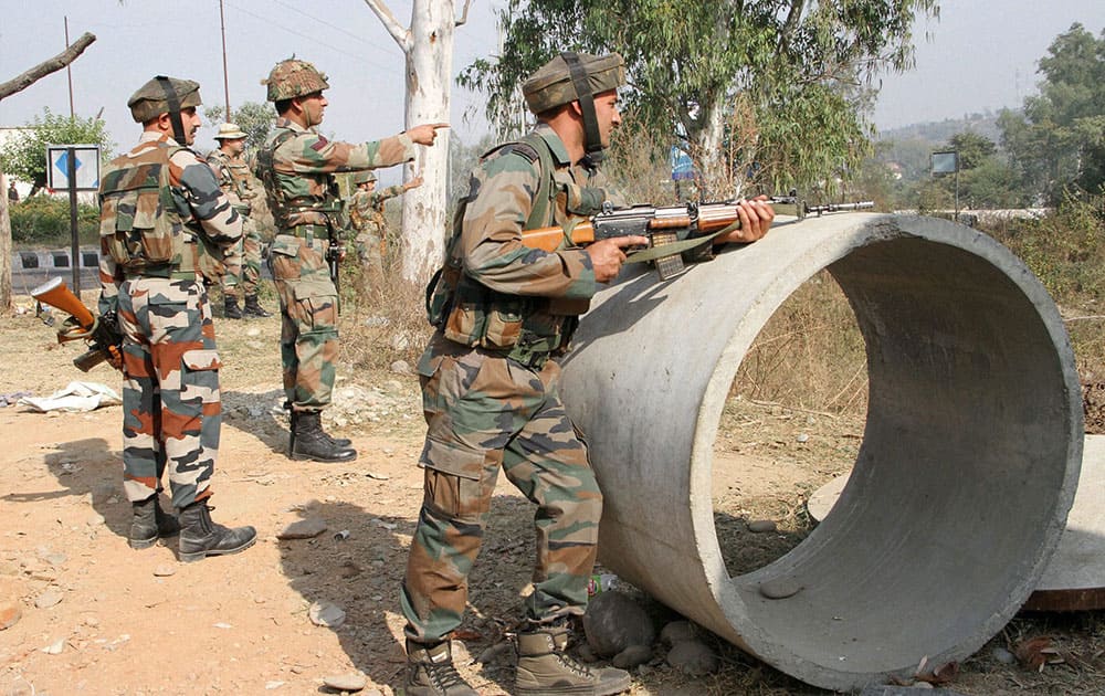 Security personnel take positions during a gun battle with suspected militants at Army camp at Nagrota near Jammu