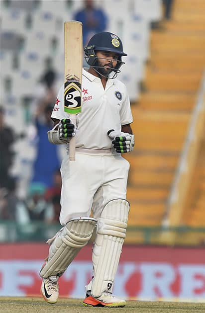 Parthiv Patel celebrates after completing a half-century on the fourth day of the third Test match between India and England in Mohali