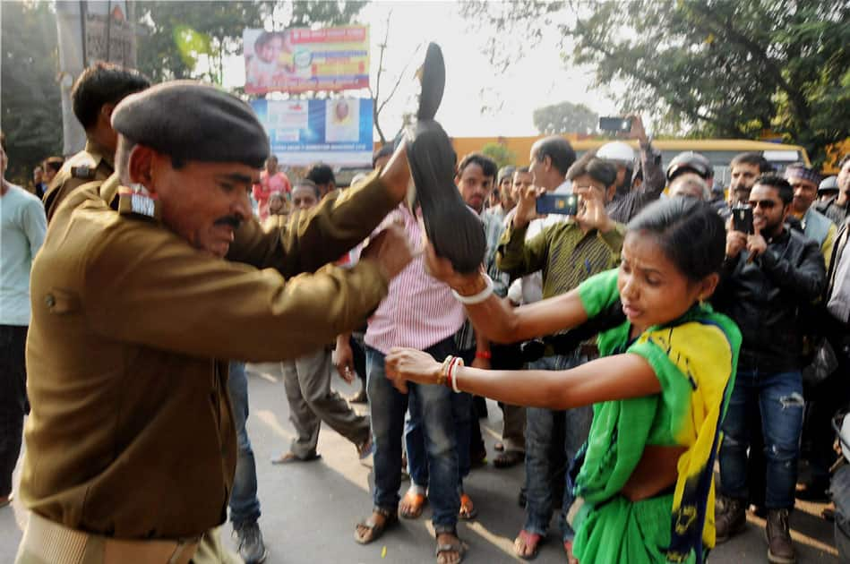 Woman beats Police man