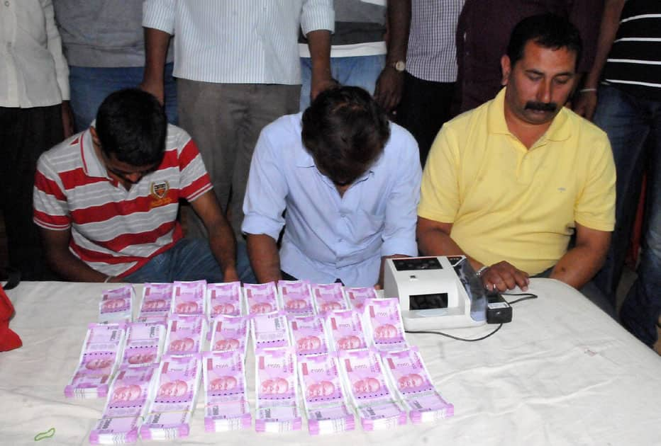 Three men arrested with cash