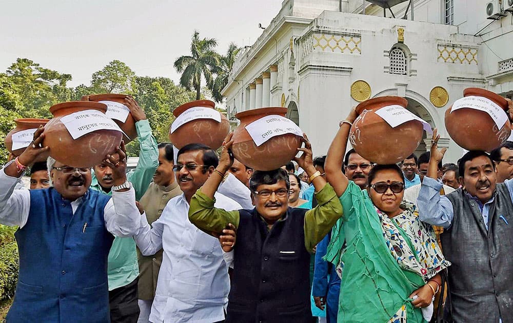 TMC MLAs carry earthen pots on their heads and shouting slogans against Prime Minister Narendra Modi