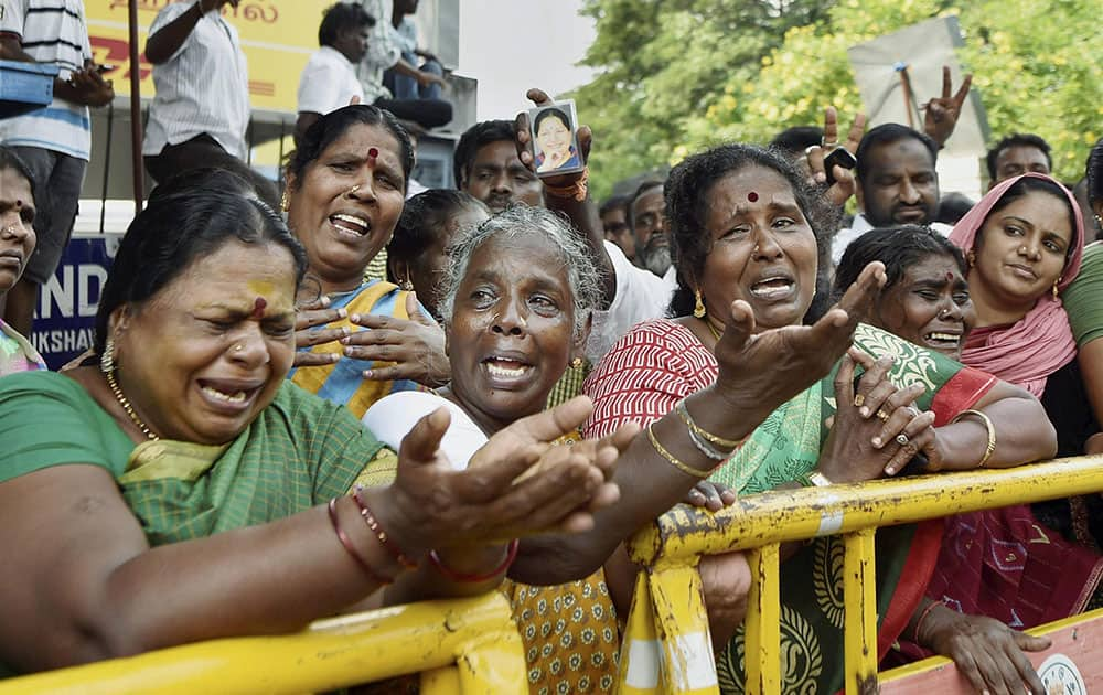 Supporters of Tamil Nadu Chief Minister Jayalalithaa cry in front of Apollo hospital after Jayalalithaa suffered a cardiac arrest, in Chennai