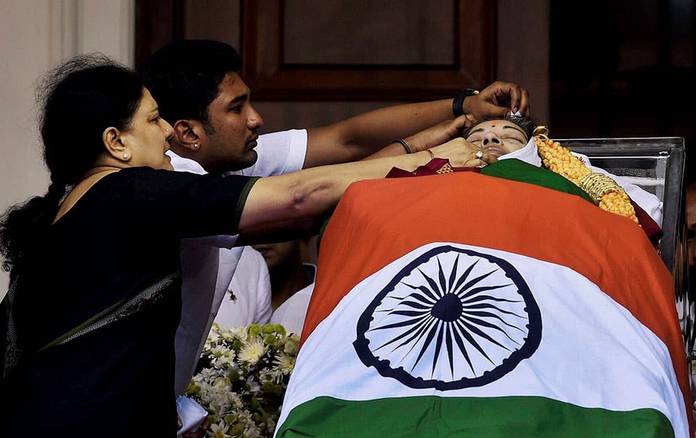 V Sasikala, the close aide of Tamil Nadus former Chief Minister Jayaram Jayalalithaa adjusts a cloth around her mortal remains