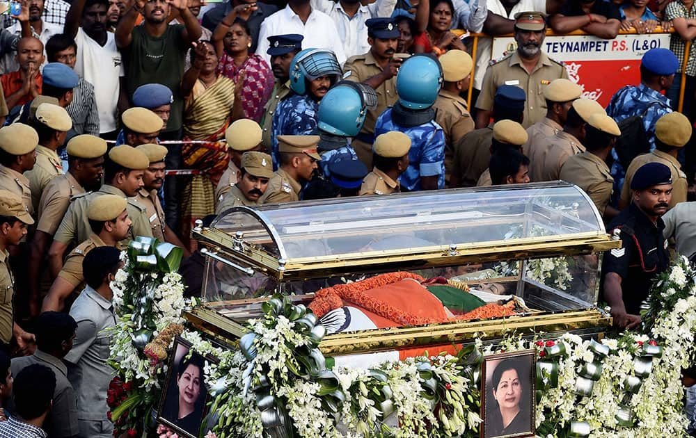 Security personnel carrying the Tamil Nadus former Chief Minister J Jayalalithaas mortal remains during her funeral procession in Chennai