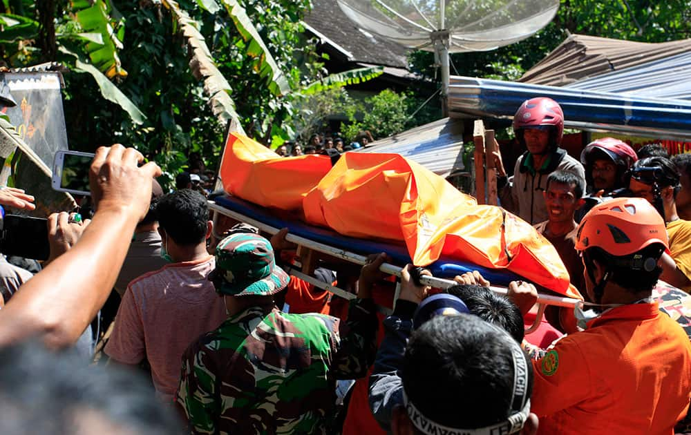 Rescue workers pull victims from destroyed buildings in Sigli, Aceh Province, Indonesia