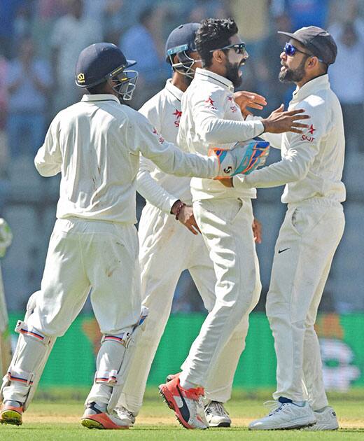 Ravindra Jadeja celebrates the wicket of England batsman Alastair Cook