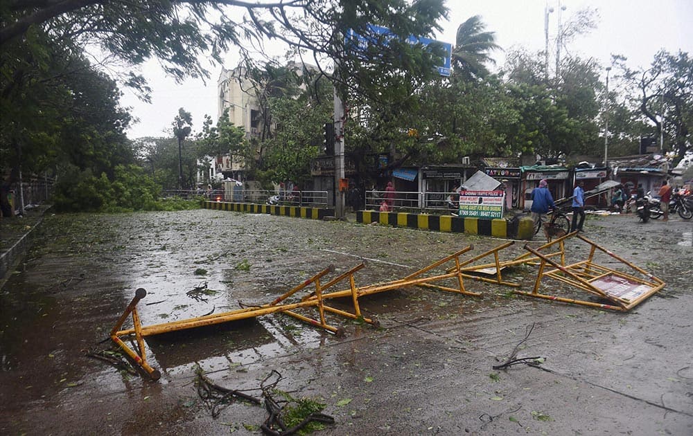 An uprooted tree blocks a road following a storm in Chennai