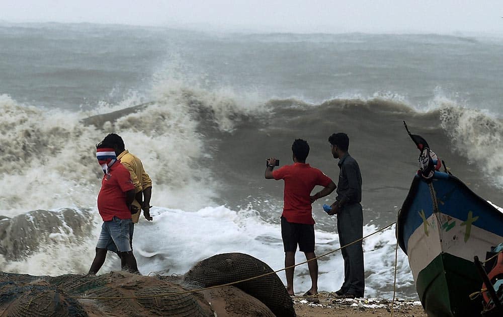 People at Marina beach as strong waves hit the coast triggered by Cyclone Vardah