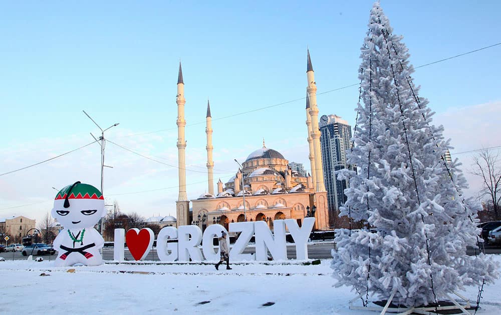 A woman walks past the main Mosque in Chechen regional capital of Grozny