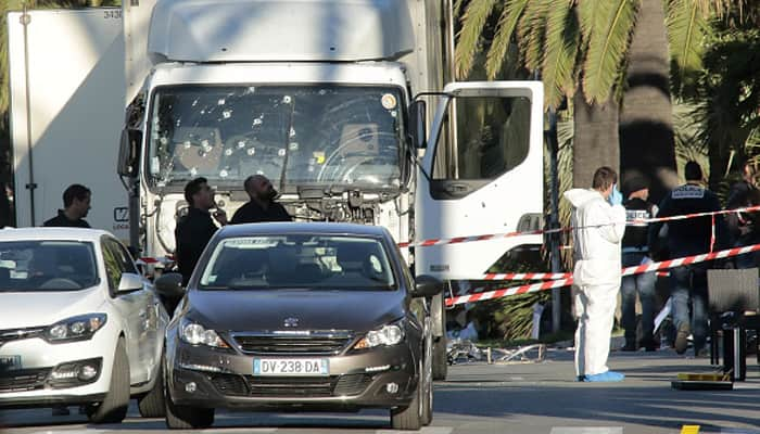 Forensic police investigate a truck at the scene of a terror attack on the Promenade des Anglais on July 15, 2016 in Nice, France.