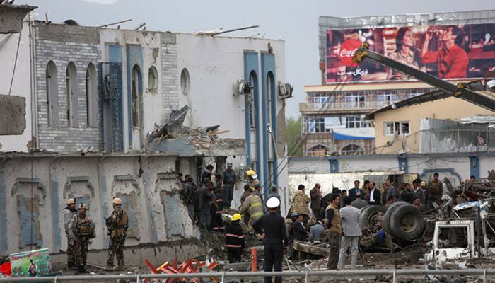 Afghan security forces inspect the site of a Taliban-claimed deadly suicide attack in Kabul, Afghanistan.