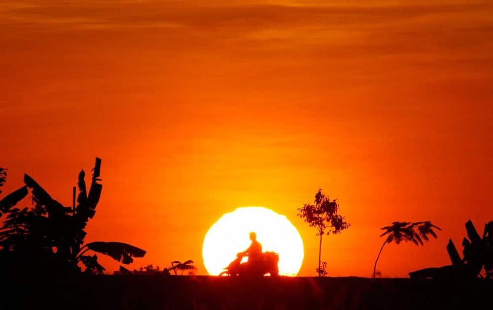 A man rides his motorcycle at sunset in Naypyitaw