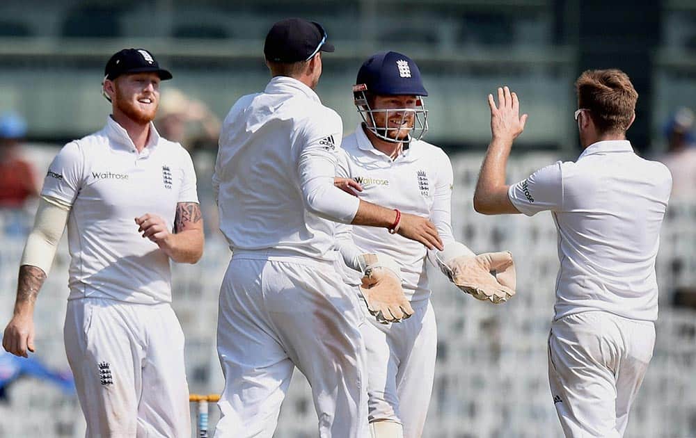 Englands L Dawson celebrates with teammates after taking the wicket of Indias Murali Vijay
