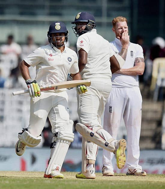 Karun Nair and R Ashwin take runs between the wicket