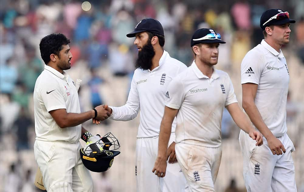 Karun Nair being congratulated by England players