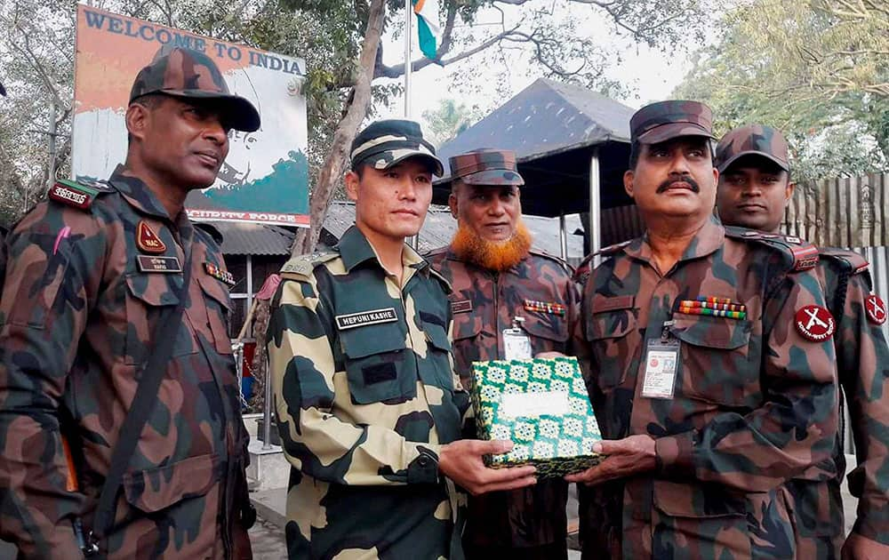 Border Guard of Bangladesh and Border Security Force personnel greet each other