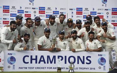 Indian cricket team poses for a group photograph with the winning trophy after registering test series win against England