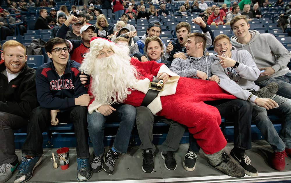 A Santa poses with fans