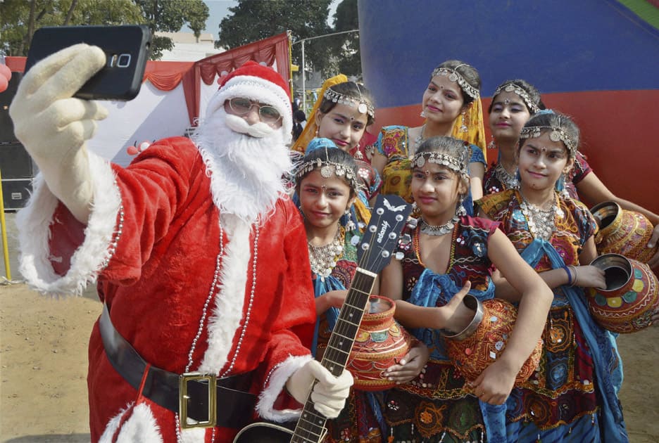 Santa Claus takes a selfie with children