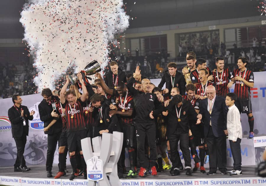 AC Milan team celebrates with the troph