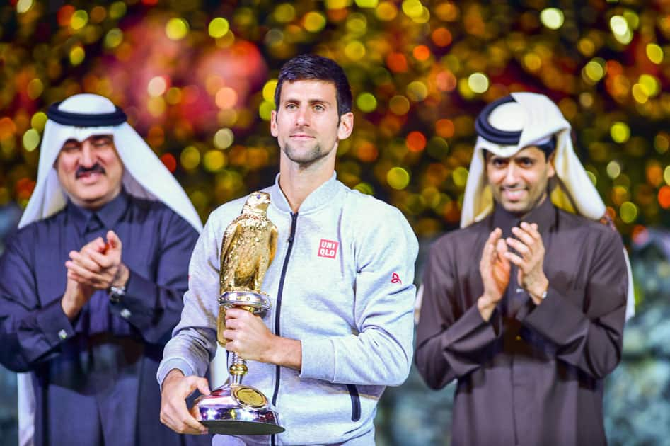 Novak Djokovic of Serbia celebrates with his trophy