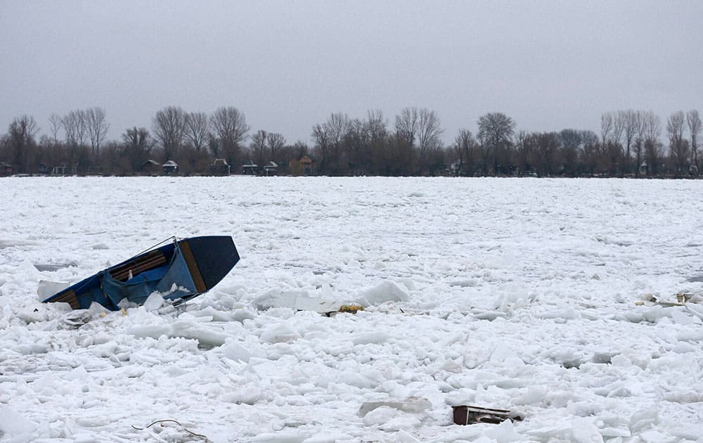 A boat is trapped in the frozen Danube river