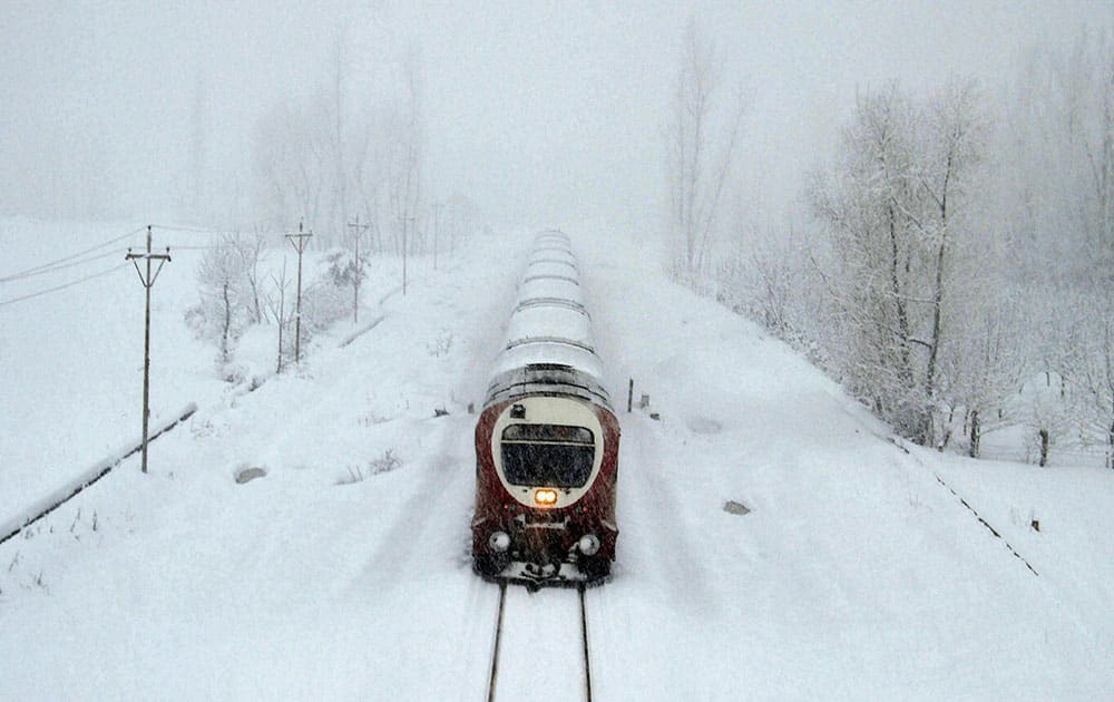 Train moves on snow covered Srinagar-Qazigund rail track