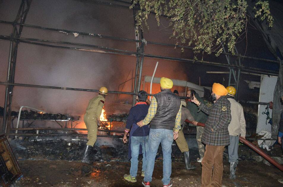 Fire fighters and locals try to douse a fire