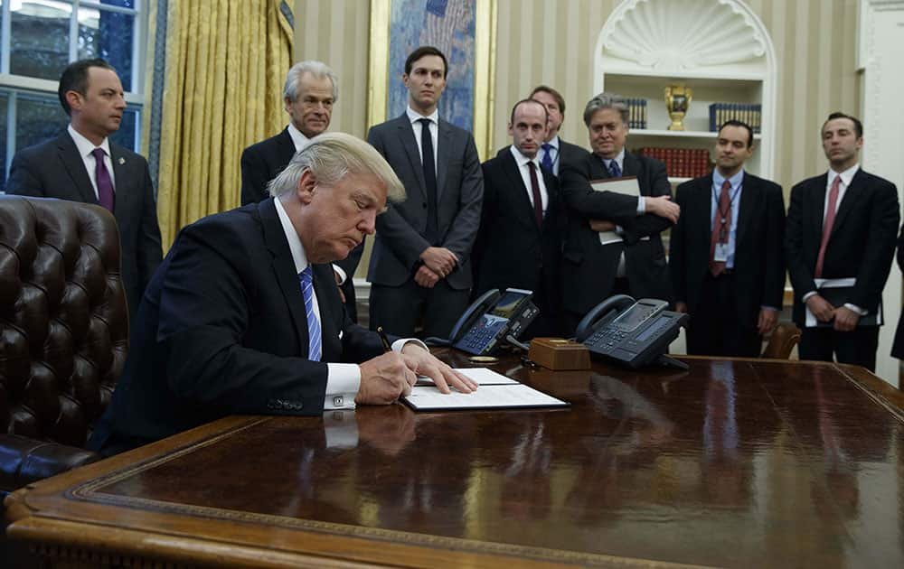 President Donald Trump signs an executive order