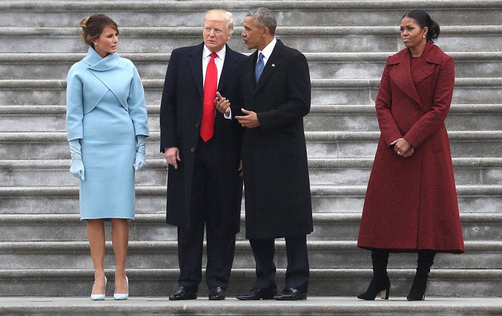 President Donald Trump and former president Barack Obama stand on the steps of the Capitol in Washington