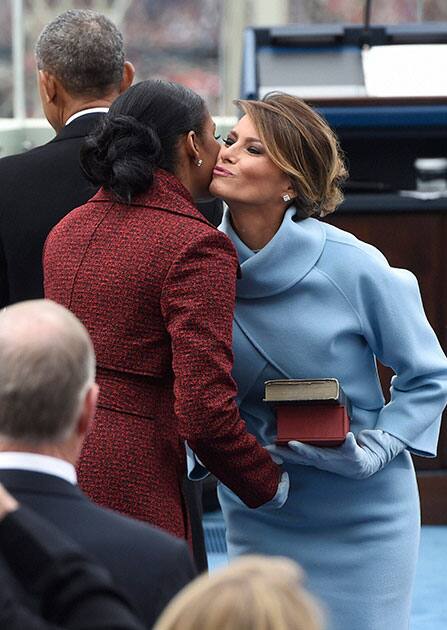 First lady Melania Trump kisses former first lady Michelle Obama