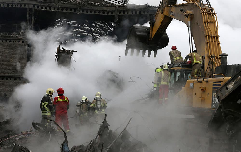 Rescuers work during the operations removing debris of the Plasco building