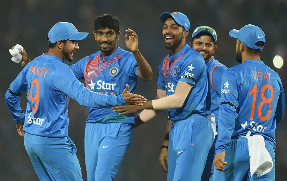 Indian players celebrate after beating England during their T20 match 