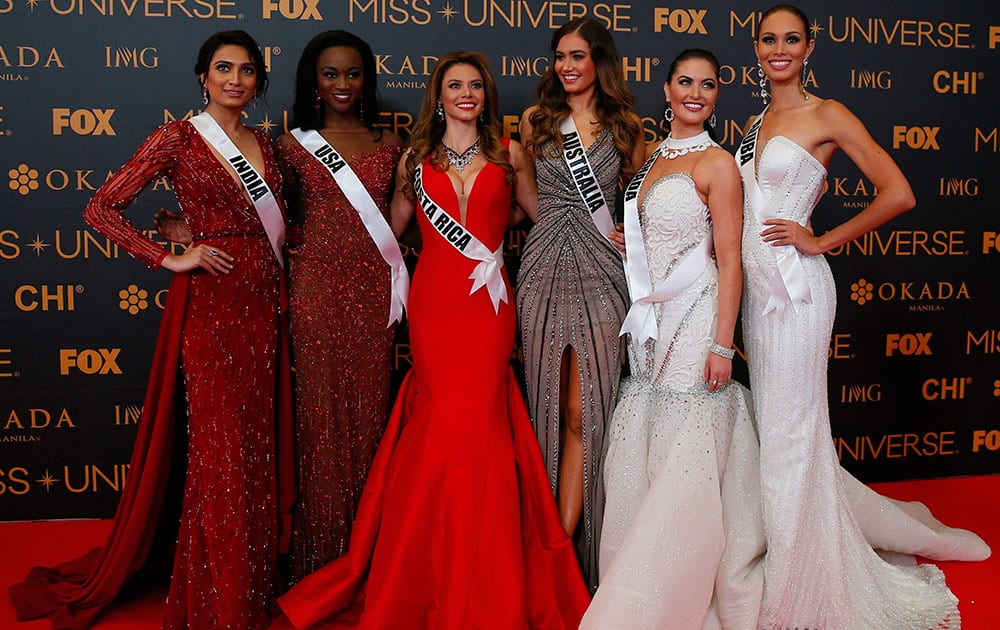 Miss Universe contestants pose on the red carpet 