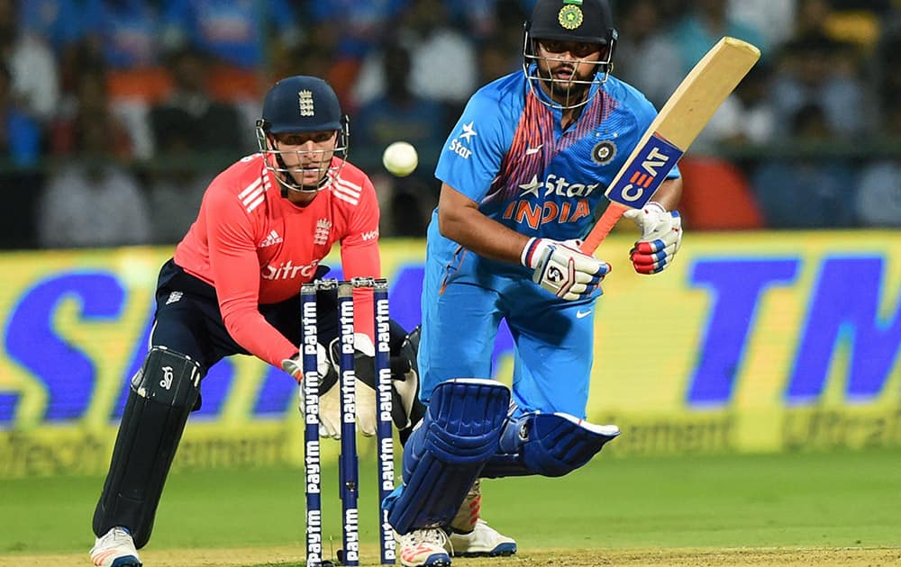 Suresh Raina plays a shot during the 3rd T20 match between India and England at Chinnaswamy Stadium in Bengaluru