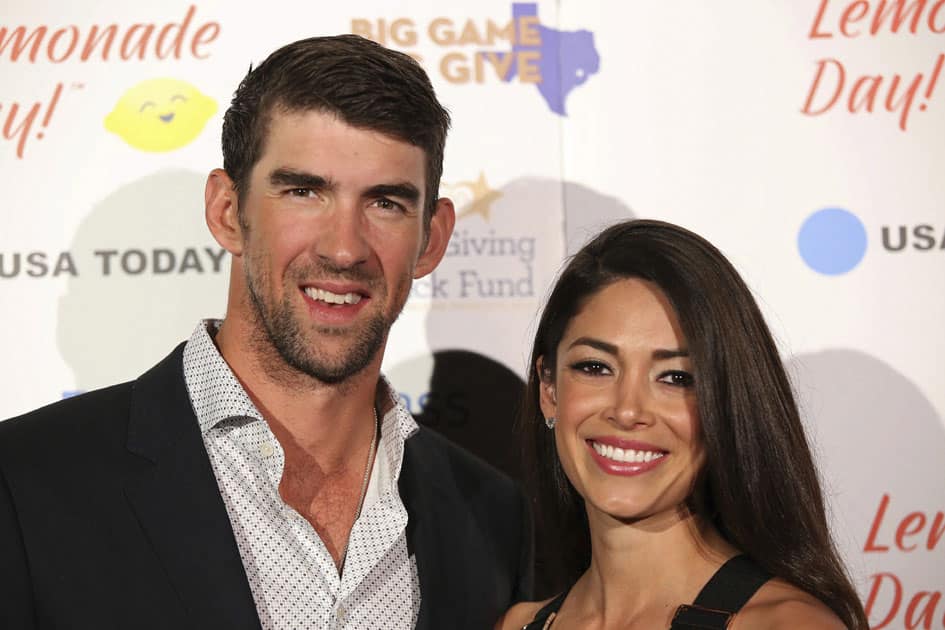 Michael Phelps and wife Nicole Johnson pose for a photograph