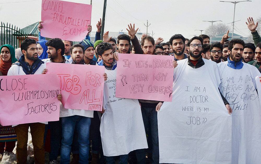 Unemployed veterinary doctors hold placards to stage a protest for jobs