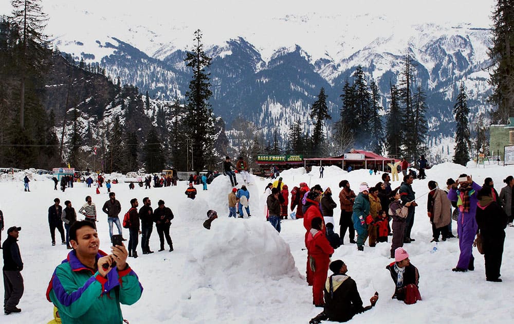 Tourists enjoy fresh snow at Solang Nala in Manali